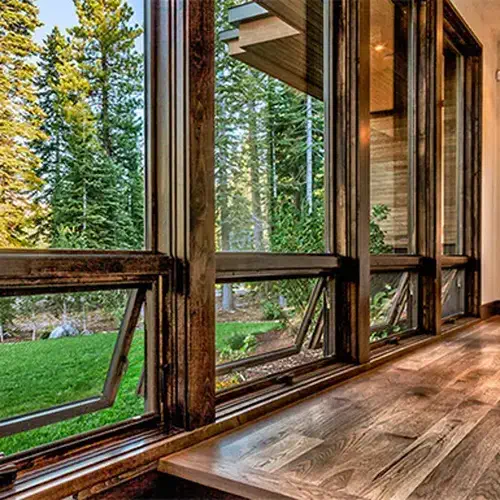 awning window macfarlane (1) Opened awning style windows, in a serene and modern setting, with a rich wooden interior. The installation and design was completed with the team from MacFarlane Windows and Doors.