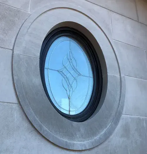 custom vinyl window macfarlane (1) An oval shaped custom vinyl window from MacFarlane windows and doors. There is also inlaid design int he glass as well as custom framing for a beautiful and modern aesthetic look.