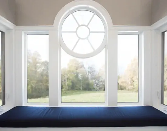 custom vinyl window macfarlane 2 (1) A custom window with an architectural flair, in a modern sitting area. The frame is white, the areas is well lit, showcasing the design that MacFarlane Windows and Doors brings to each project.